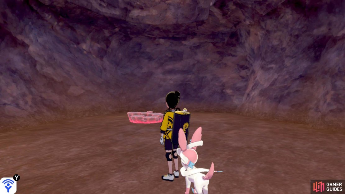 Go up the slope that&rsquo;s adjacent to the underground stream, on the Training Lowlands side. Halfway along, there&rsquo;s a small area with a roaming Druddigon. At the top of the slope, go forward and slightly right. The one&ndash;and only&ndash;den&rsquo;s just ahead.