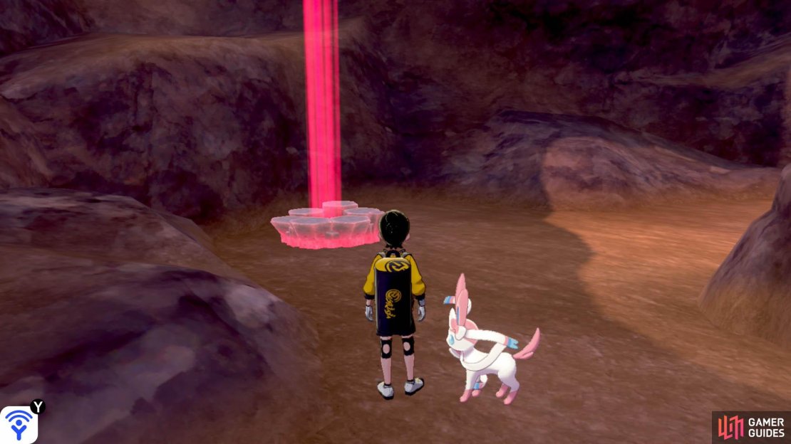 Where the path splits in multiple directions, go down the slope on the left side. Continue past the area with the Druddigon. At the bottom, you&rsquo;ll find three dens. This one is to the left of the middle rock.