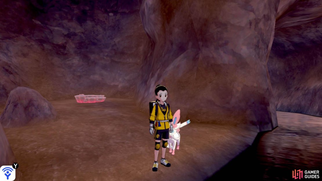 Where the path splits in multiple directions, go up the slope towards the centre. Head into the underground stream on the left and swim forward for a while. Eventually, there&rsquo;s a bit of land on the left, before exiting the cavern. This den is over there.