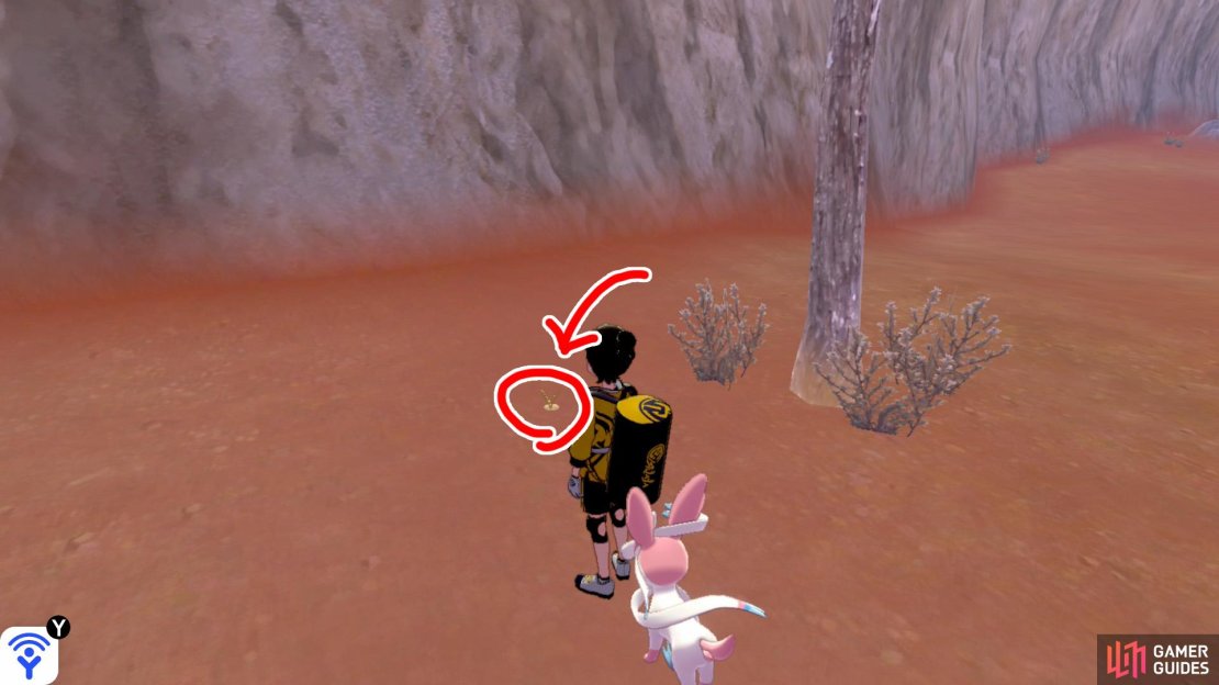 6/10: Again, keep following the cliff wall in a clock-wise manner. Once you reach the next boulder with a Pok&eacute;mon Den nearby, go past the den and check around the tall tree.