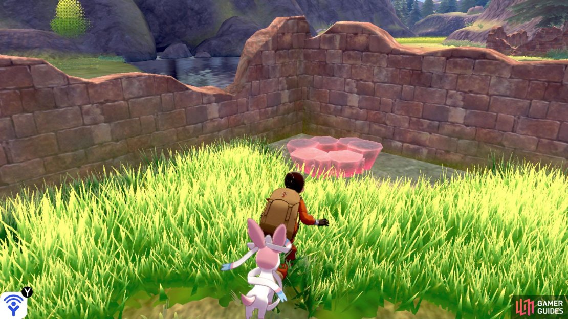 After crossing the river, turn left and go in-between the building ruins. Take the next left. There should be a berry tree here. Head for the farthest corner and you&rsquo;ll find this den through some tall grass.
