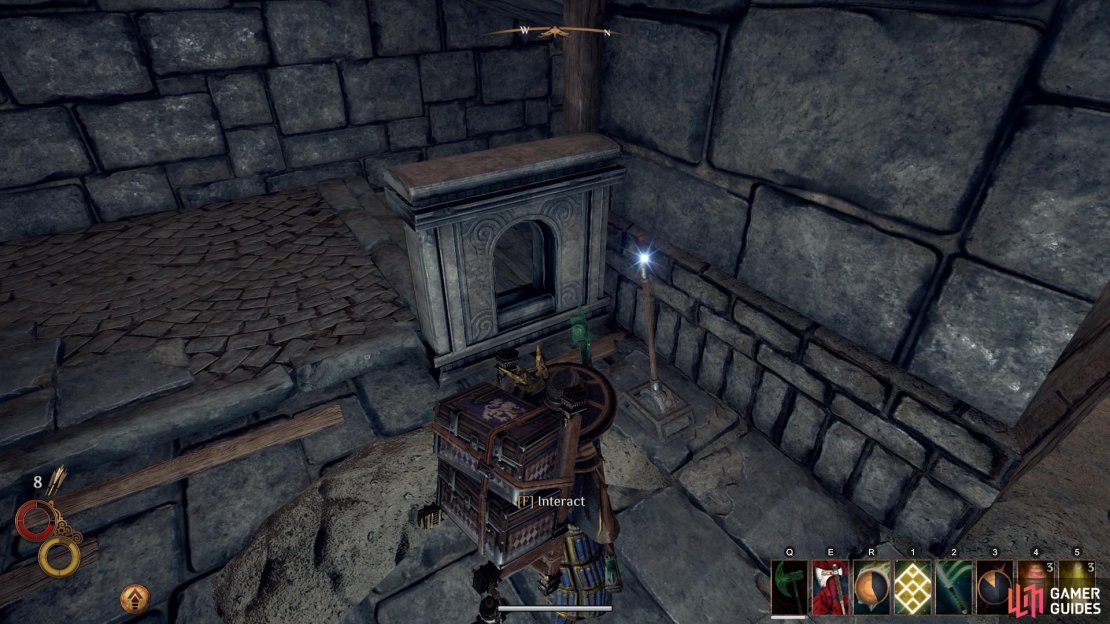 Use the lever at the top of the stairs to open the gate below.