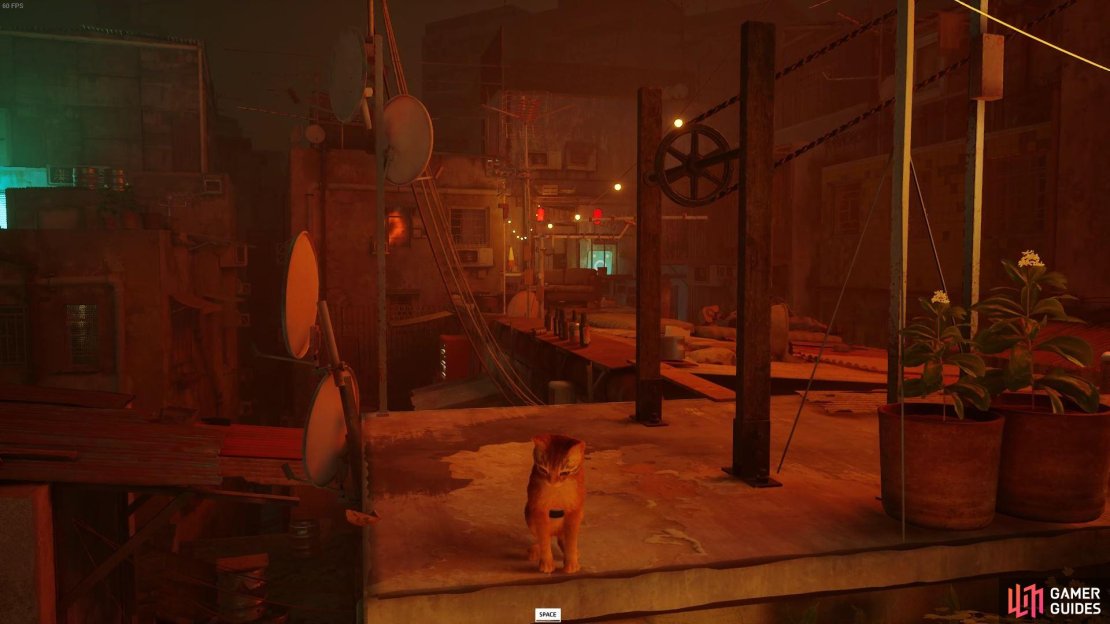 The red vending machine is towards the edge of the opposite building&rsquo;s roof