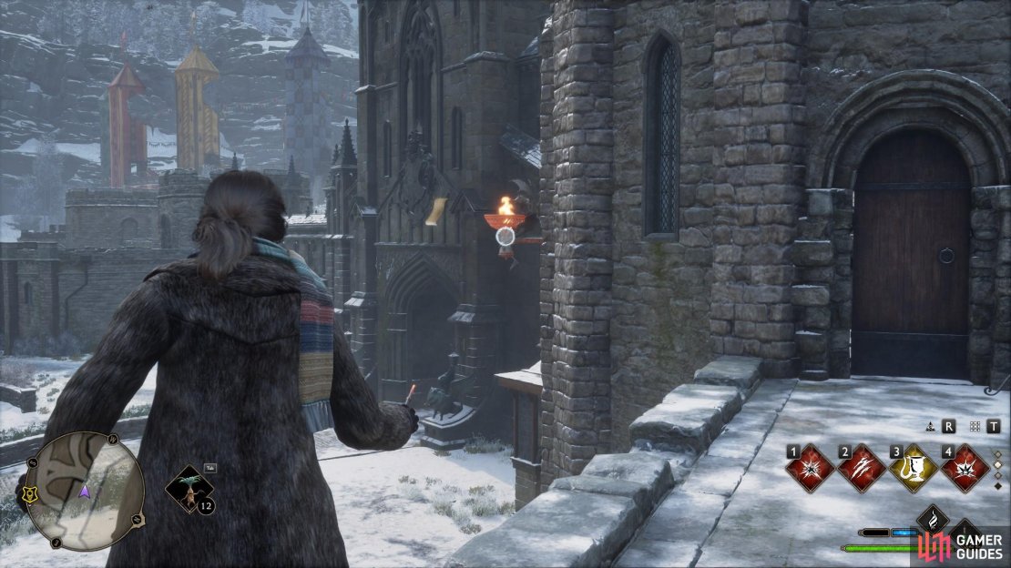 On the outside wall of the carriage building is a brazier you need to ignite.