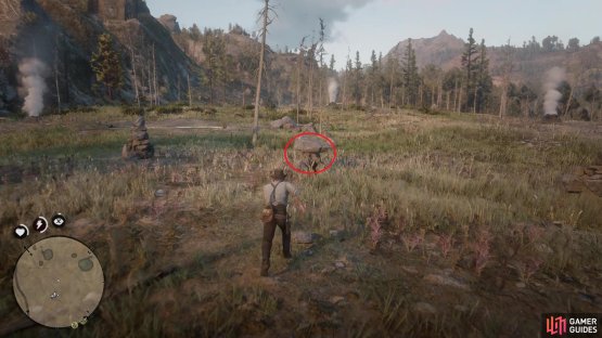 Look for the cairn with a large rock on top