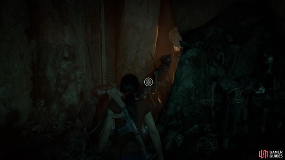 Pull the skeleton from the wall to find a way through