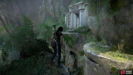 Stand at the ledge in front of the door at the top of the room
