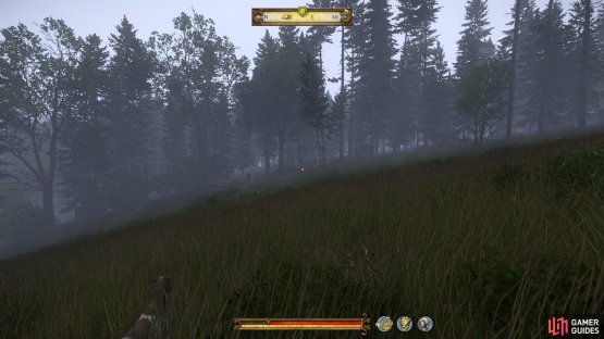 The camp can be seen at the edge of the woods once you&rsquo;ve descended down the hill.