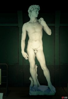 The real statue is not holding a book