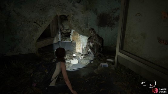 then crawl through the gap in the wall to find an Artefact by a body. 