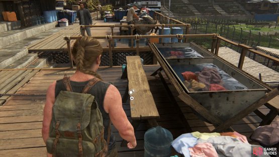 then go downstairs to find another Coin on the bench where people are cleaning clothes. 