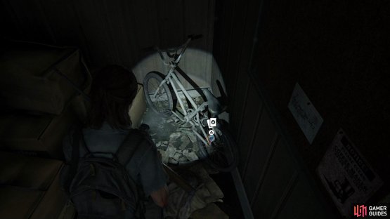 Look to the right of the building to find this Trading Card under the bike