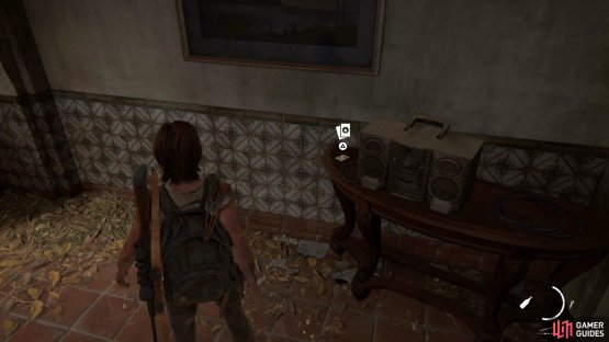 Head inside the building to find the Trading Card sitting by a radio