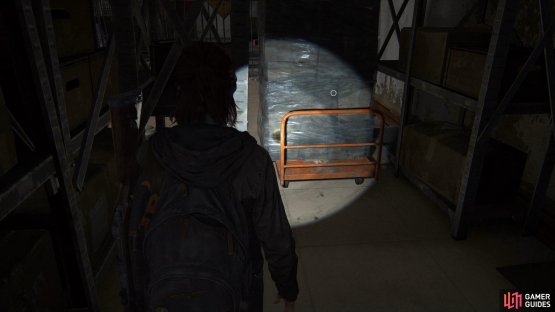 then grab the trolley from the back left of the room to climb up to the second floor.