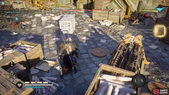 on the floor in the upper courtyard, next to some crates.