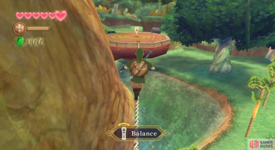 On a platform connected by a tightrope, on the south side of the large, central tree.