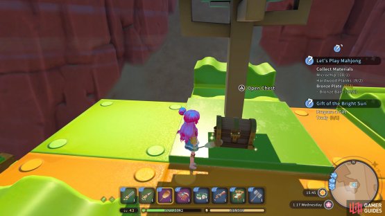 The chest is located beside the toy tree.