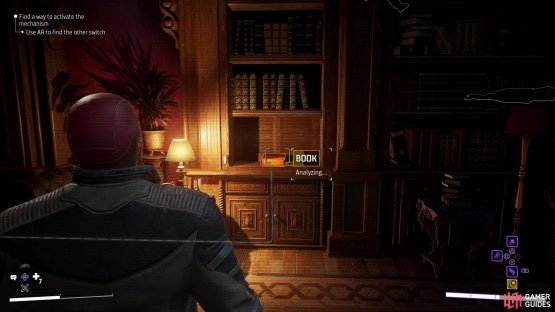 then backtrack and drop over a railing to the right to find a book with a hidden button near some stairs.