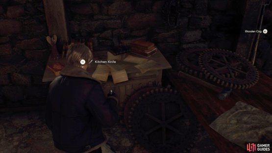 The Kitchen Knife will be on the table to the left of the Wooden Cog.