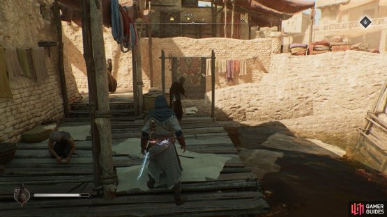 You are looking for an NPC near a rug on the river dock.