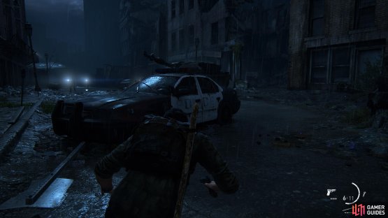 Hide behind this car and enter the room on the right