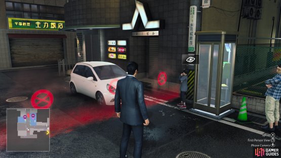 He will be standing right next to the telephone booth, in front of the parking lot.