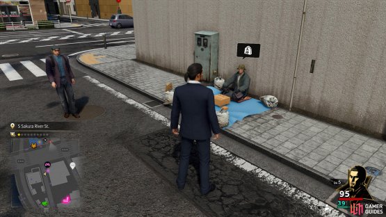 The guy will be sitting on the ground, right by the street corner.