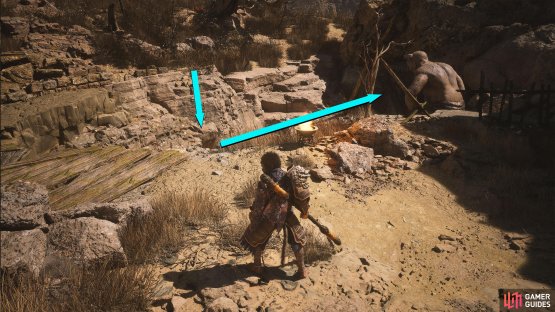 From the Village Entrance Shrine, drop into the gap and head into the cave to your right.