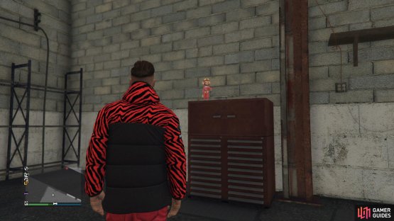 to find the action figure sitting on top of the toolbox.