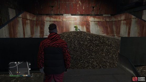 to find the action figure sitting on a wood chip pile. 