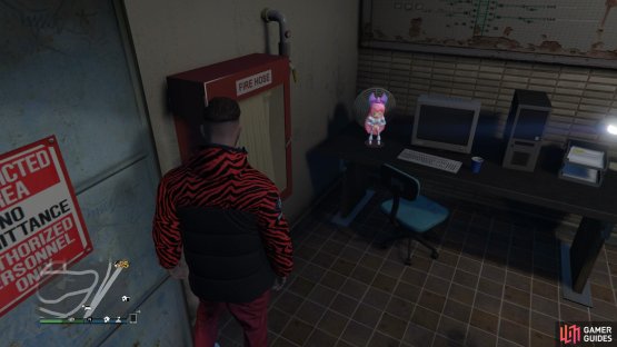 to find the action figure sitting on a desk.