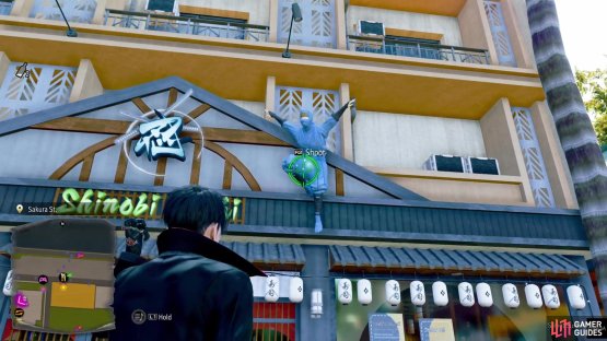 Look above the entrance to the Shinobi Sushi shop, on the statue there.