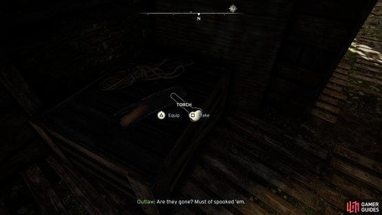 Be wary of Outlaws and grab a Torch on a crate just inside the building.