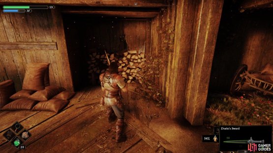 A little way down that walkway, you will find some wood that can be destroyed, allowing you to enter the building.