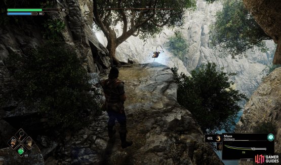 The Crow is on the edge of the cliff to the right of the bridge.