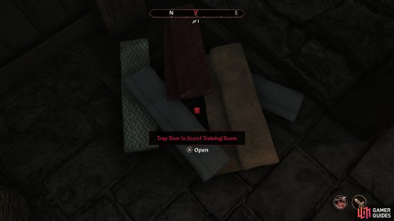 Find a trap door buried under some cloth,