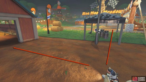 Cut across the grass to the right of the starting flag and enter the barn.