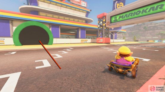 Take the green pipe on the building next to the starting flag.