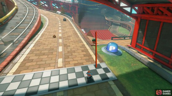 From the starting flag, drive on the nearby red roof.