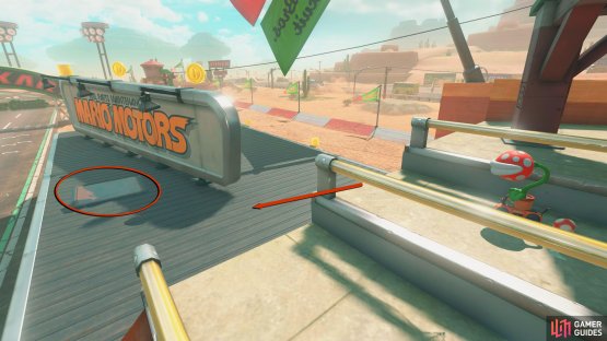 From the mountain, drive over to the stands, and go back toward the starting flag to find the panel on the roof.