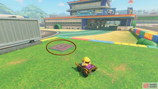 Perform a charged jump to clear the barrier to get on the raised platform. The panel will be behind the sign.