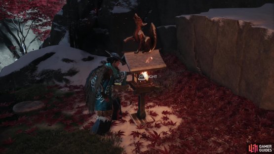 Get a torch from the brazier nearby and light the two stone lanterns with a fox statue on top.