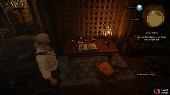 You can find the key you need on a book along the northern end of the room.