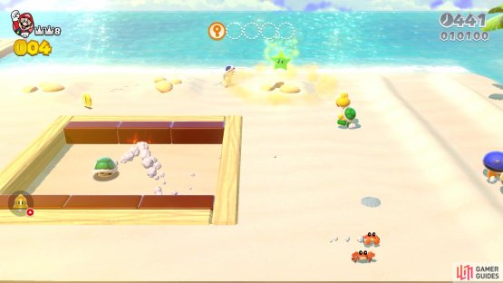 The first Green Star appears when you destroy the Goomba sand sculpture