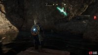 Look for the wooden platform with the light above it, where the entrance to the underwater cave can be found.