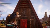 Shoot the wooden barricade at the back of the triangular house.