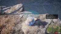 Then, place the second largest rock carefully upon the first rock. 