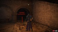 At the bottom of the stairs, turn around and interact with the lever.